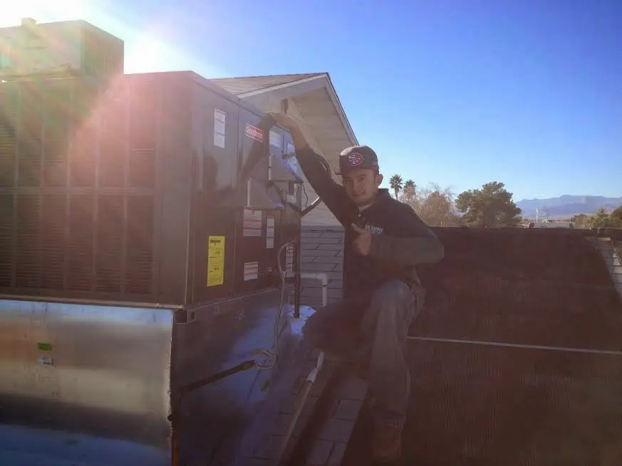 HVAC technician performing HVAC Inspection on a rooftop unit in Beekmantown